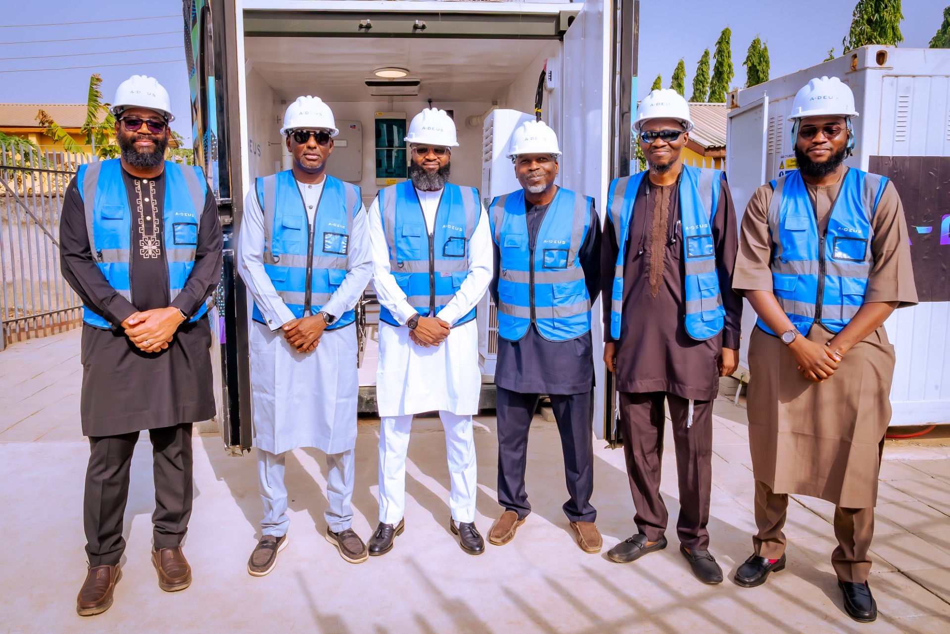 A-DEUS launch team standing at the Abuja commercial showcase site.